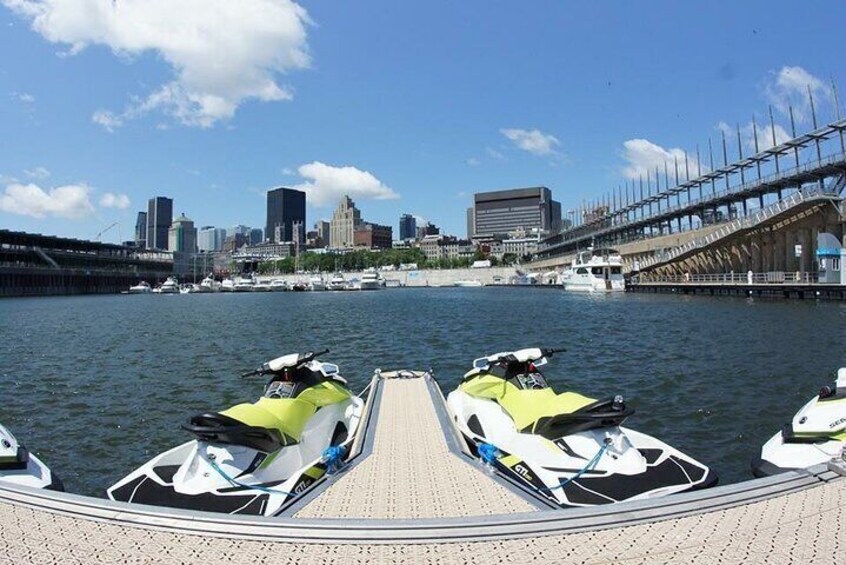 A jet ski dock with a city skyline in the background. 5