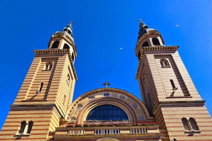 A historic building with two tall towers and a large arched entrance. 5