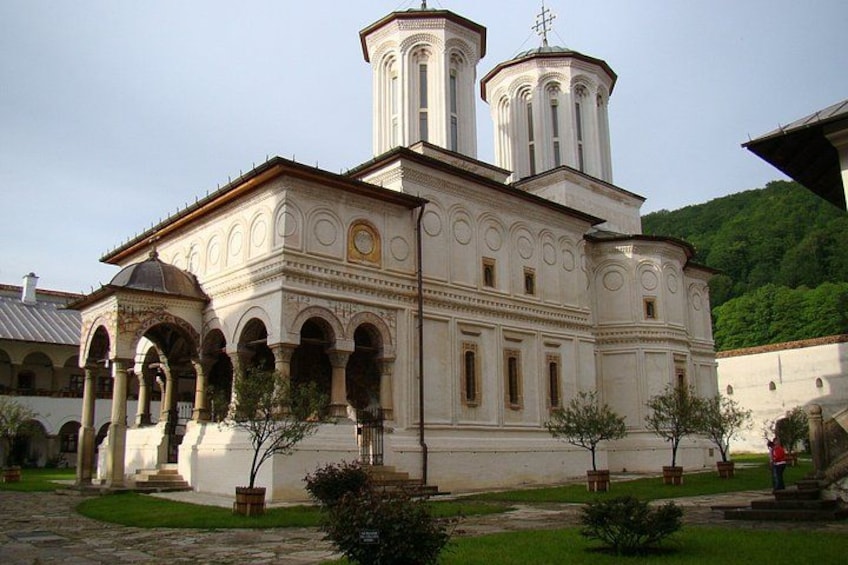 A white church with a bell tower and arched windows. 3