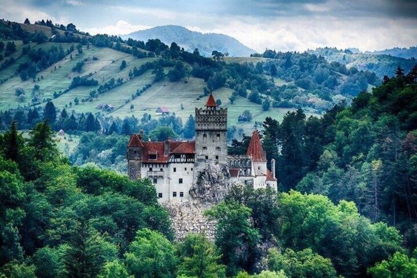 A castle surrounded by lush green hills. 5