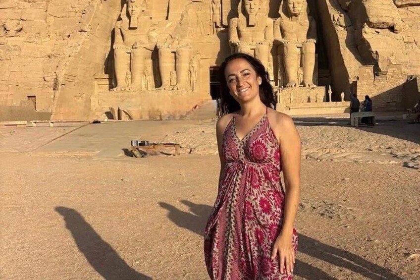 A person standing in front of ancient Egyptian statues. 5