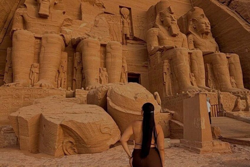 A large ancient Egyptian temple with massive statues and hieroglyphs. 2