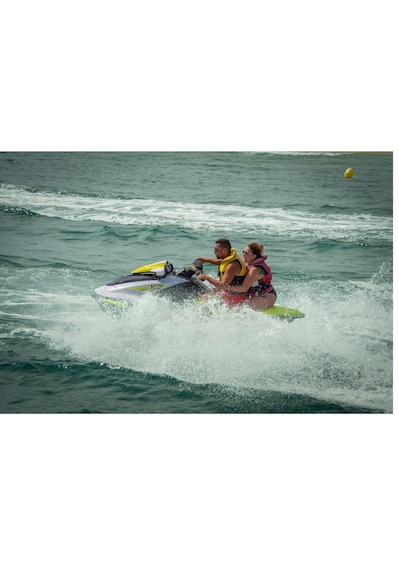 Two people jet-skiing on a body of water. 3