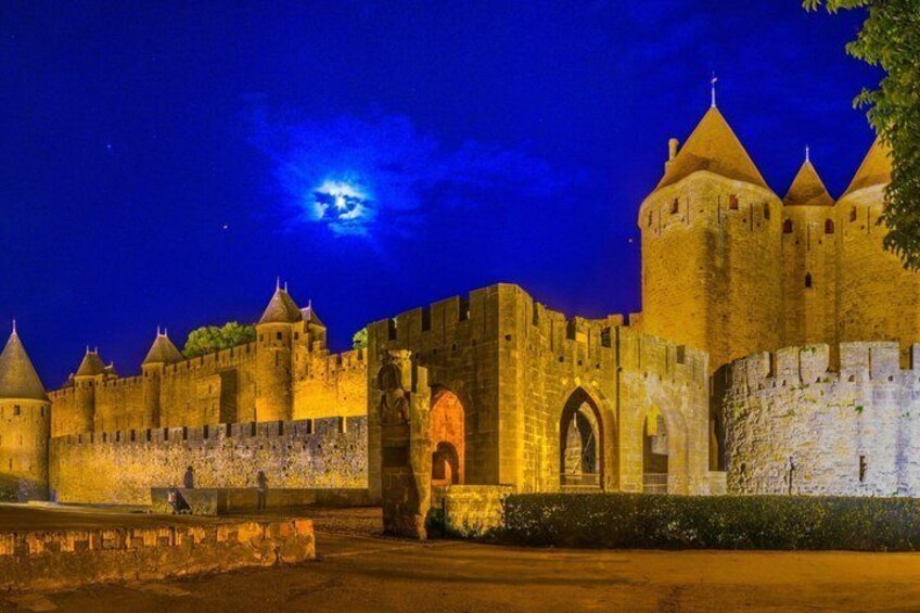 A medieval castle at night with a full moon in the sky. 4