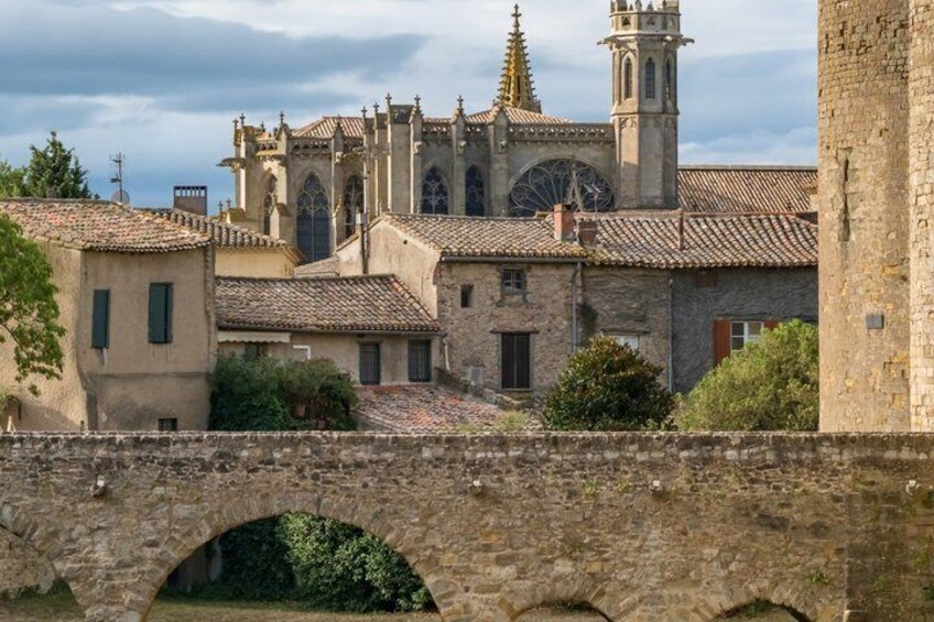 A stone bridge, a church with a bell tower, and a stone building. 2