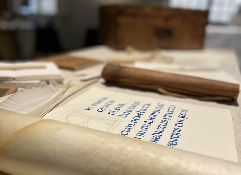 A rolled-up document with handwritten text and a rolled-up scroll. 1