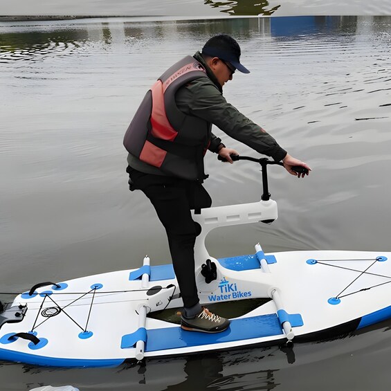 A person riding a water bike on a calm body of water. 2
