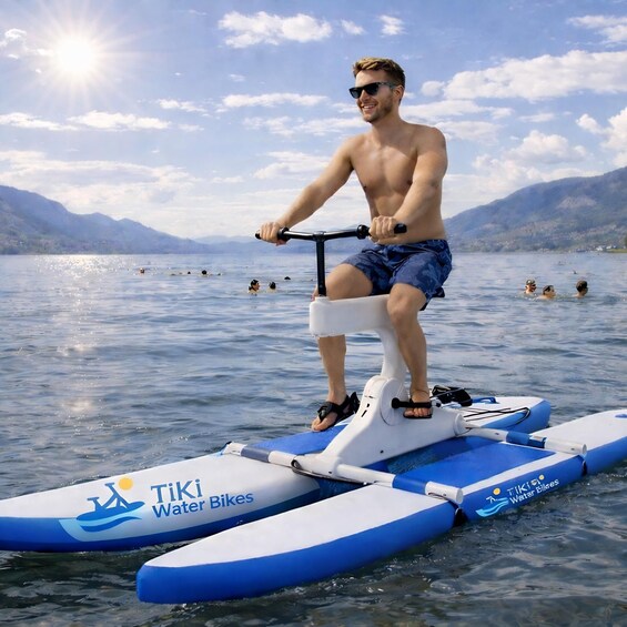 A person riding a water bike on a lake with mountains in the background. 1