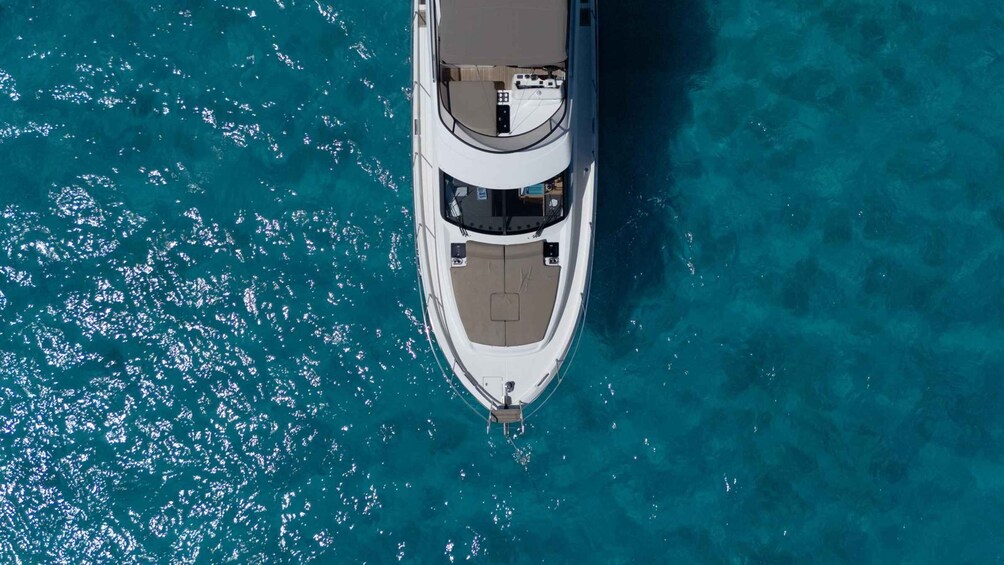 A white yacht anchored in clear turquoise waters. 3
