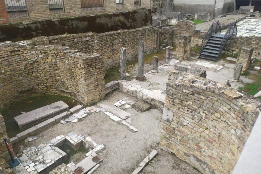 Ancient ruins with stone walls and scattered stone blocks. 5