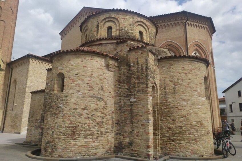 A historic stone tower with arched windows and a brick base. 4