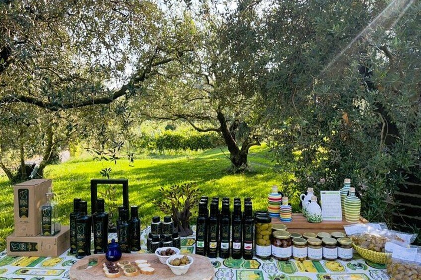 A table set outdoors with various food items and condiments. 5