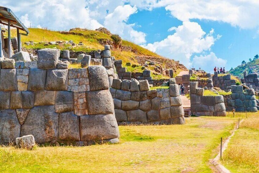 Ancient stone ruins with a pathway leading through them. 1