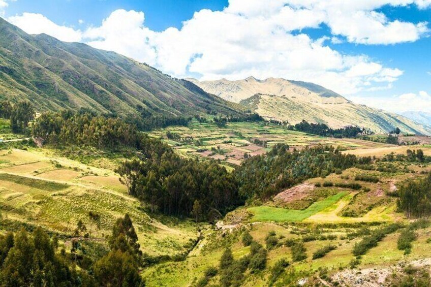 A mountainous landscape with green valleys and a clear sky. 4