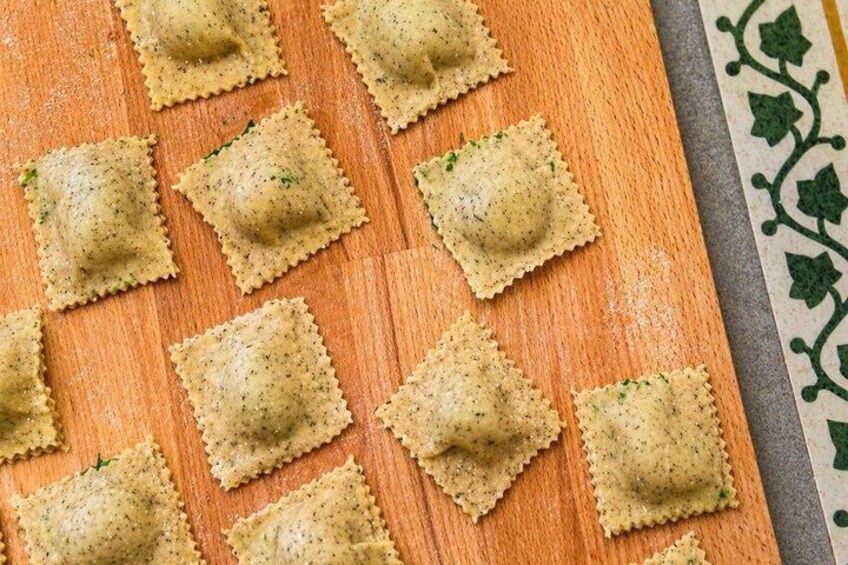 Ravioli arranged on a wooden board. 5