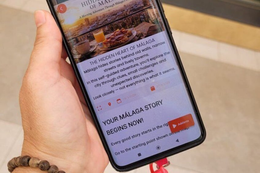 A smartphone displaying a travel article about Málaga. 5