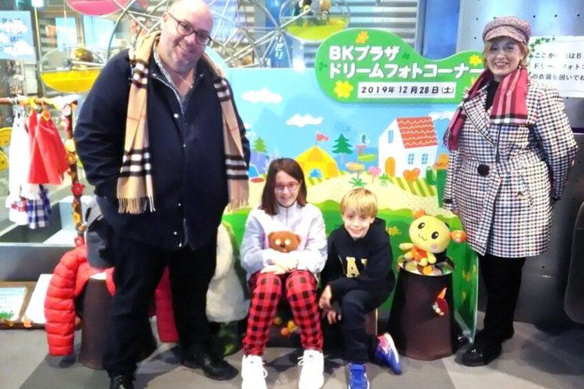 A man, a woman, and two children at a booth with a colorful backdrop. 5