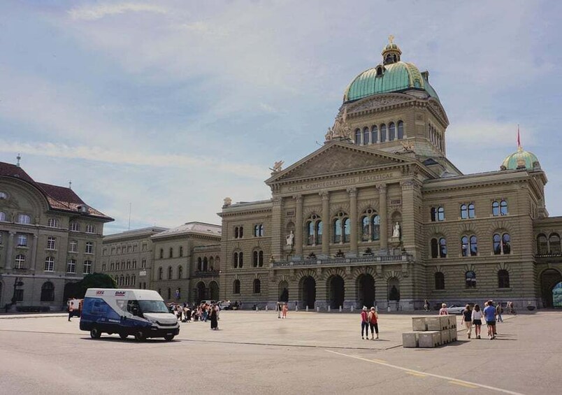 A large historic building with a prominent dome and arched windows. 3