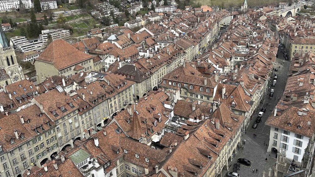 A densely packed urban area with historic buildings and a prominent church tower. 5