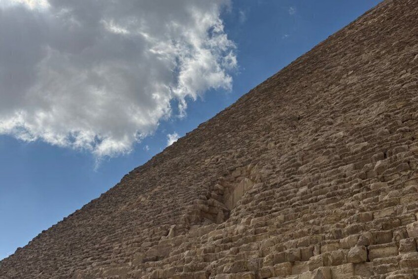A large stone wall with a clear sky above. 4