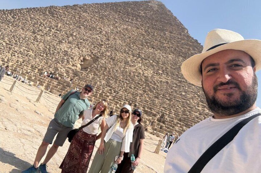 A large pyramid structure with tourists in the foreground. 2