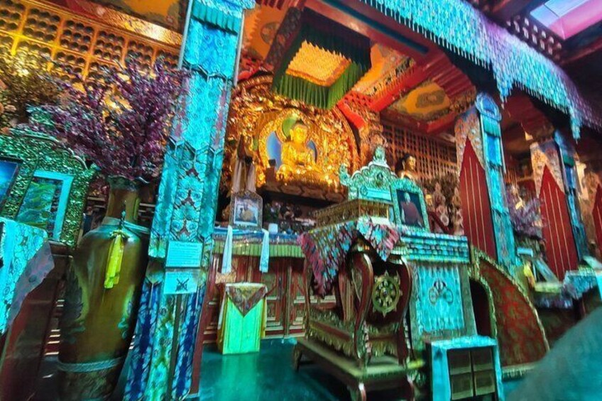 A richly decorated shrine with intricate carvings and vibrant colors. 2