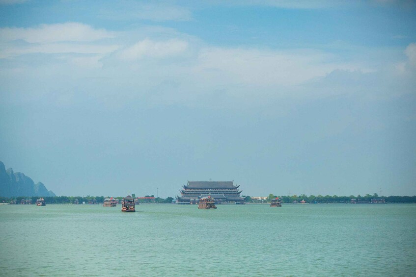 A traditional building on a river with boats. 3