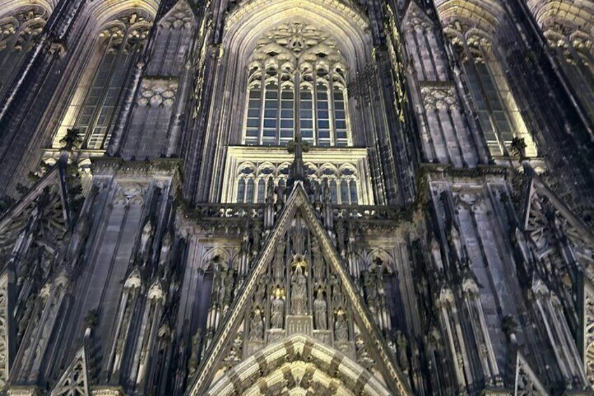 A Gothic cathedral with intricate stonework, pointed arches, and a large central window. 1