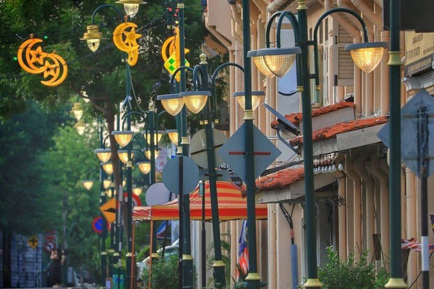 A street lined with ornate street lamps and buildings with European architectural style. 4