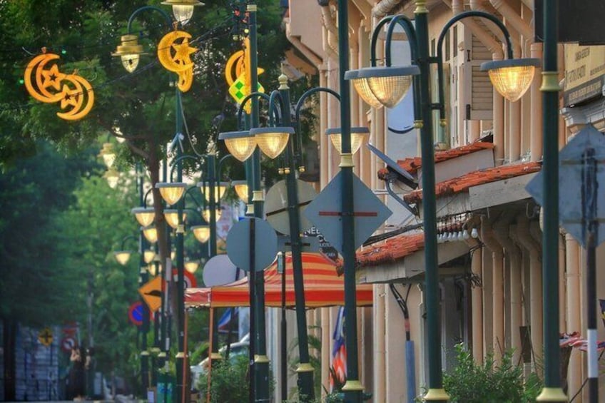 A street lined with ornate street lamps and buildings with European architectural style. 4