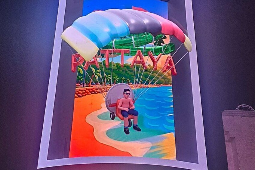 A colorful mural with a parachute, a person in a wheelchair, and the word 'PATTAYA' in the background. 5