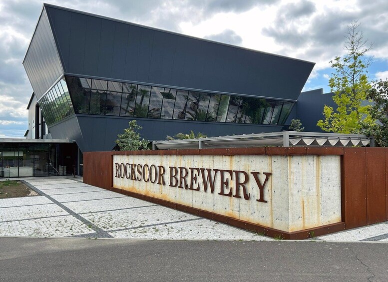 A modern building with a sign that reads 'ROCKSCOR BREWERY.' 2