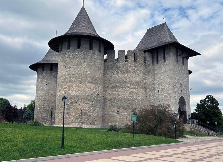A historic stone castle with two conical towers and a central entrance. 1