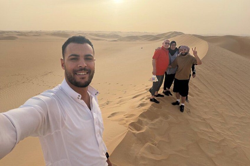 A desert landscape with sand dunes and a person taking a selfie. 1