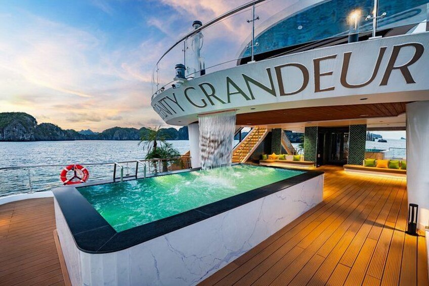 A luxurious yacht deck with a swimming pool, a lifebuoy, and the name 'GRANDEUR' on the railing. 4