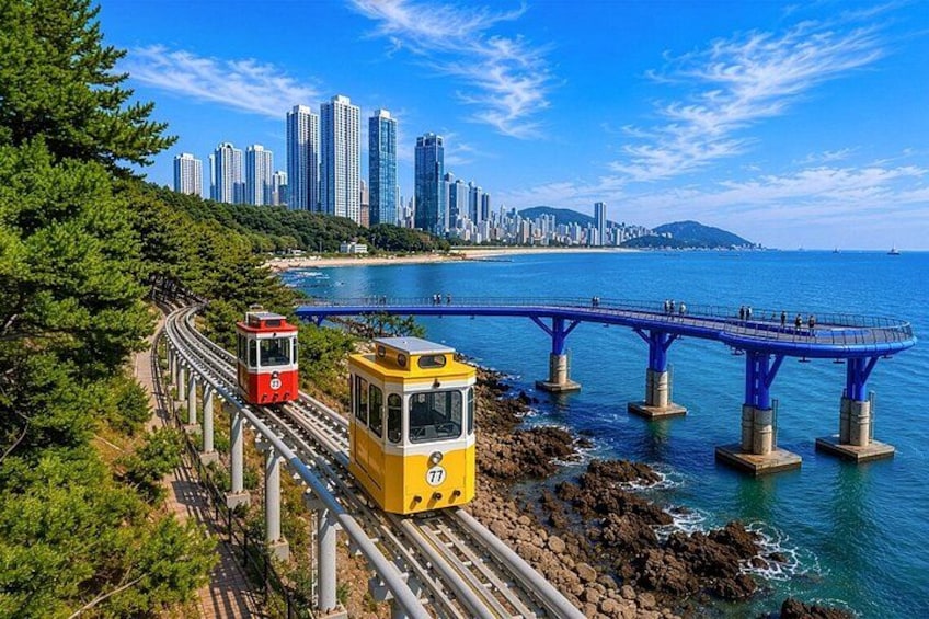 A coastal cityscape with a tram track, a bridge, and high-rise buildings. 1