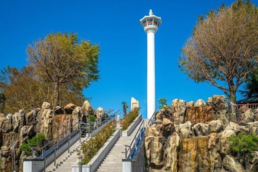 A white lighthouse, a staircase, and rocky terrain. 4