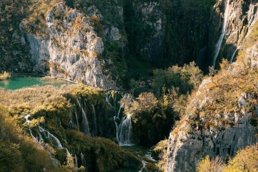 A mountainous landscape with a waterfall, a river, and a lake. 3
