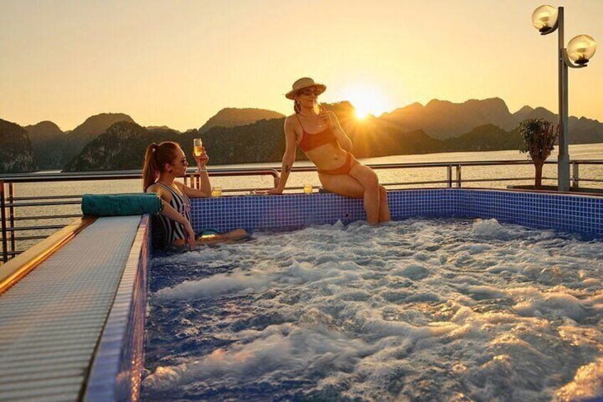 A couple relaxing in a hot tub with a scenic mountain view at sunset. 4