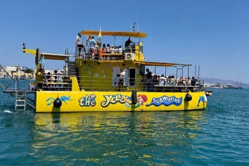 A yellow submarine-themed boat with passengers, named 'the Yellow Submarine,' on the water. 3