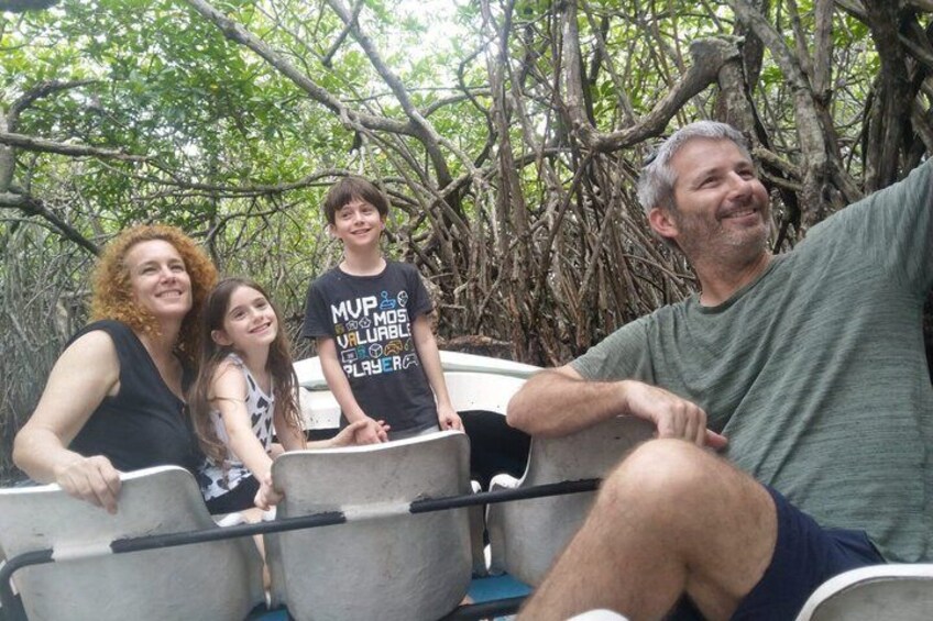 A group of people on a boat in a mangrove area. 1