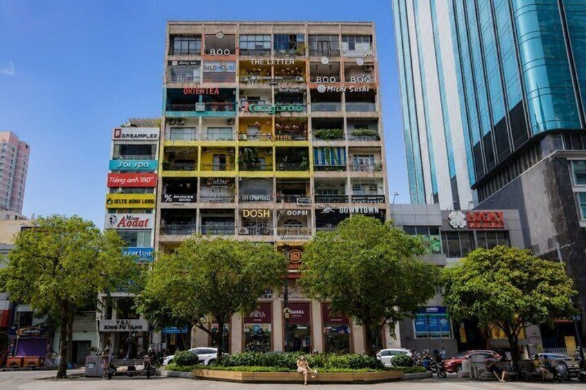 A multi-story building with various business signs, including 'BOO,' 'THE LETTER,' and 'MICHAEL'S.' 3
