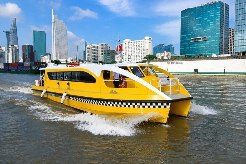 A yellow boat with 'NO ANCHORING' on its side, moving through water with a city skyline in the background. 2