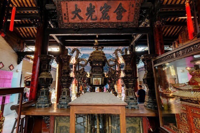 An ornate shrine with traditional Chinese architecture, featuring intricate woodwork and a central altar. 4