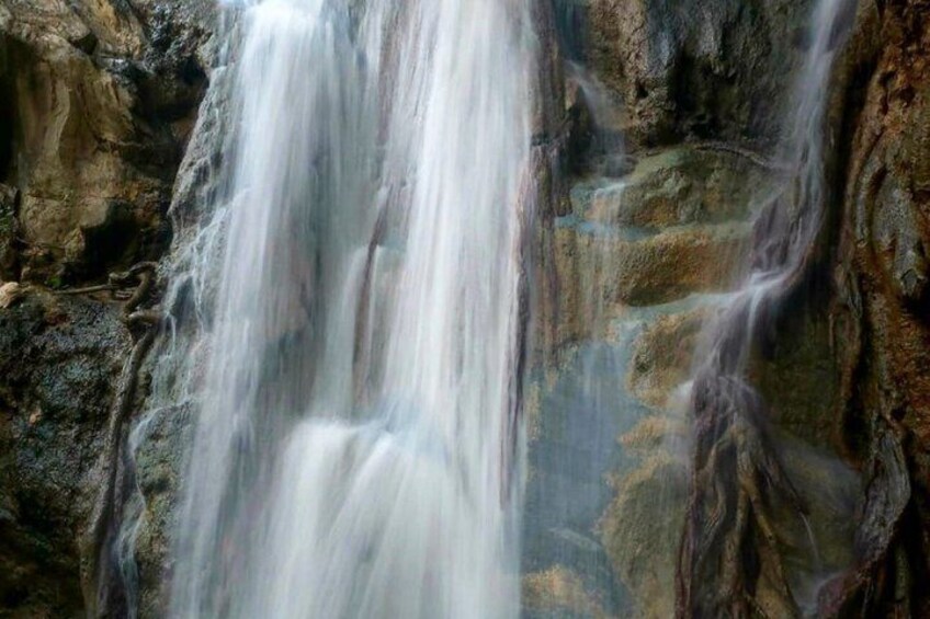 A waterfall cascading over rocky terrain. 4