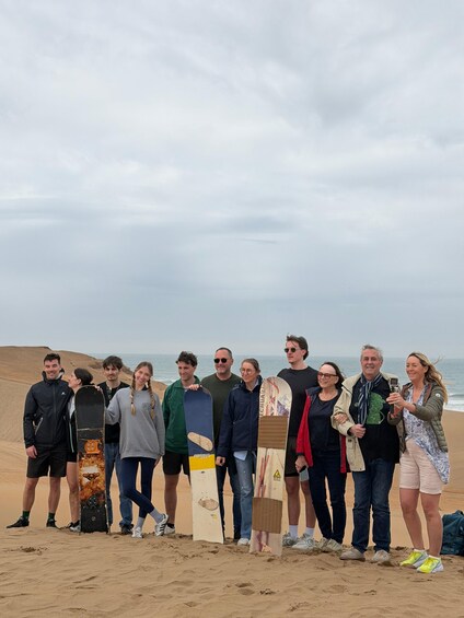A group of people on a beach with surfboards. 2