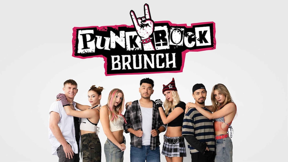 A group of people posing for a photo with a Punk Rock Brunch banner above them. 1
