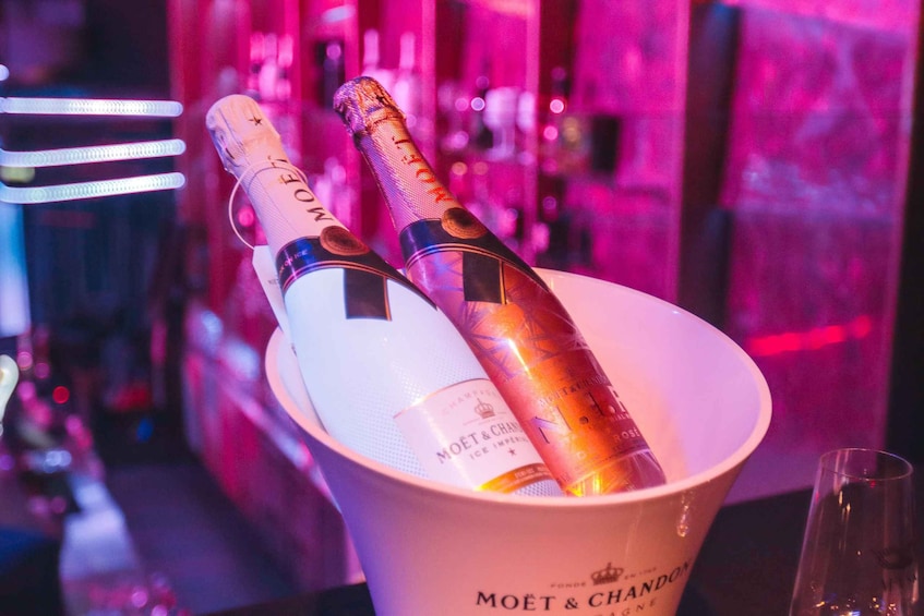 Two champagne bottles in a bucket labeled 'MOËT & CHANDON.' 1