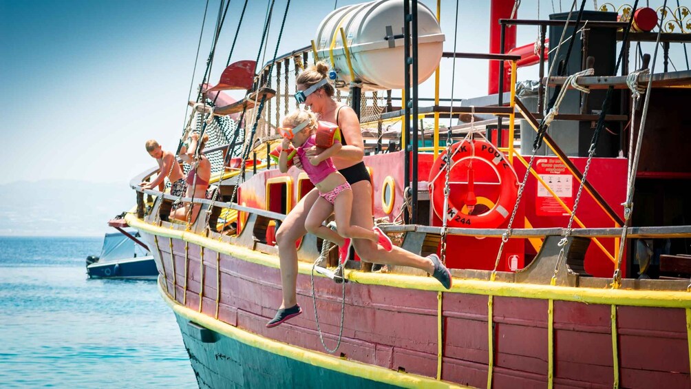 A person climbing a rope on a boat. 4