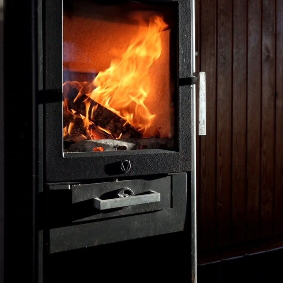 A wood-burning stove with a visible fire. 3